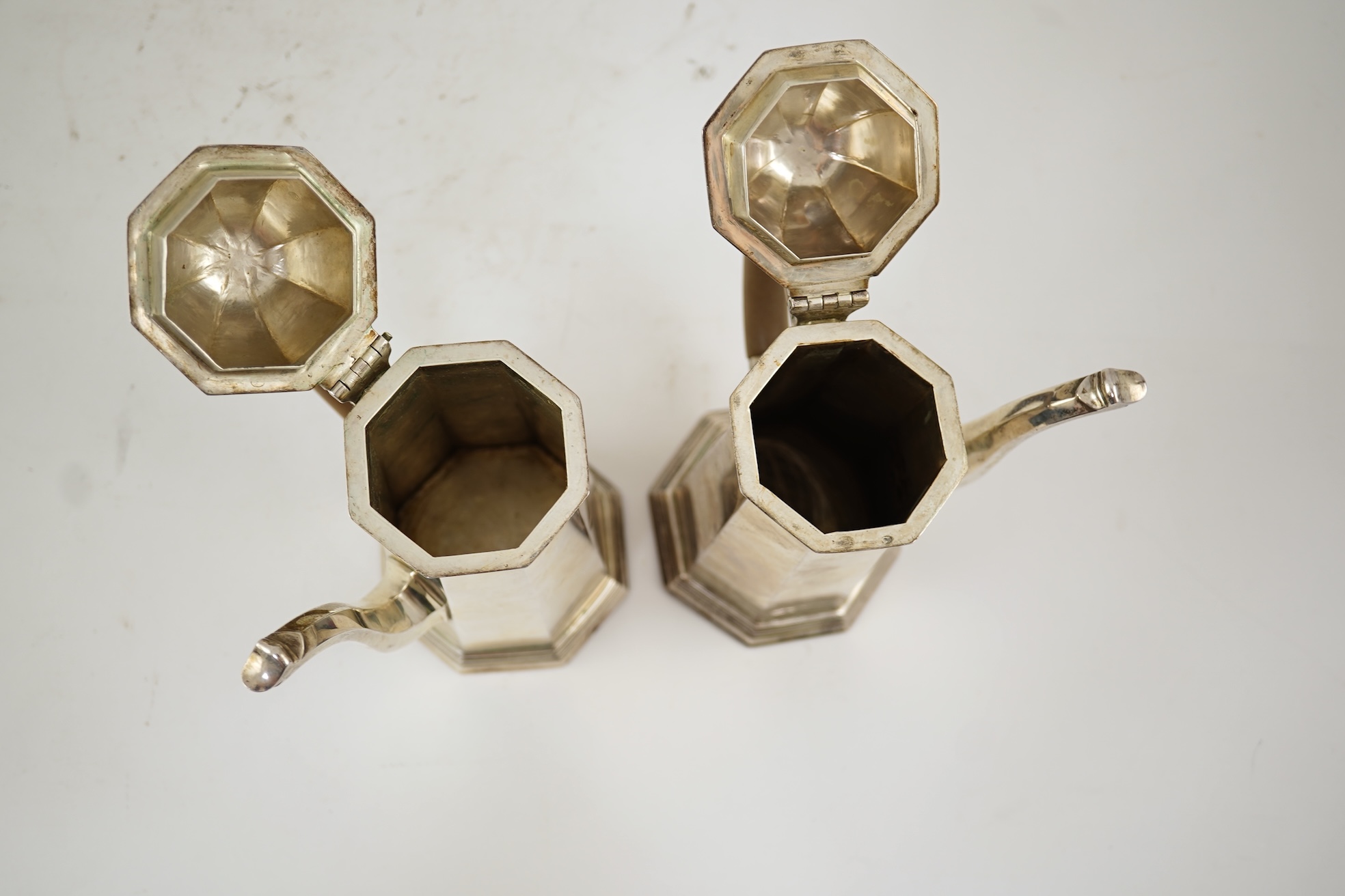 A pair of George V octagonal silver café au lait pots, by William Comyns & Sons Ltd